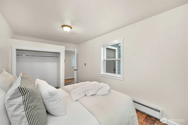 a bedroom with a bed and a window