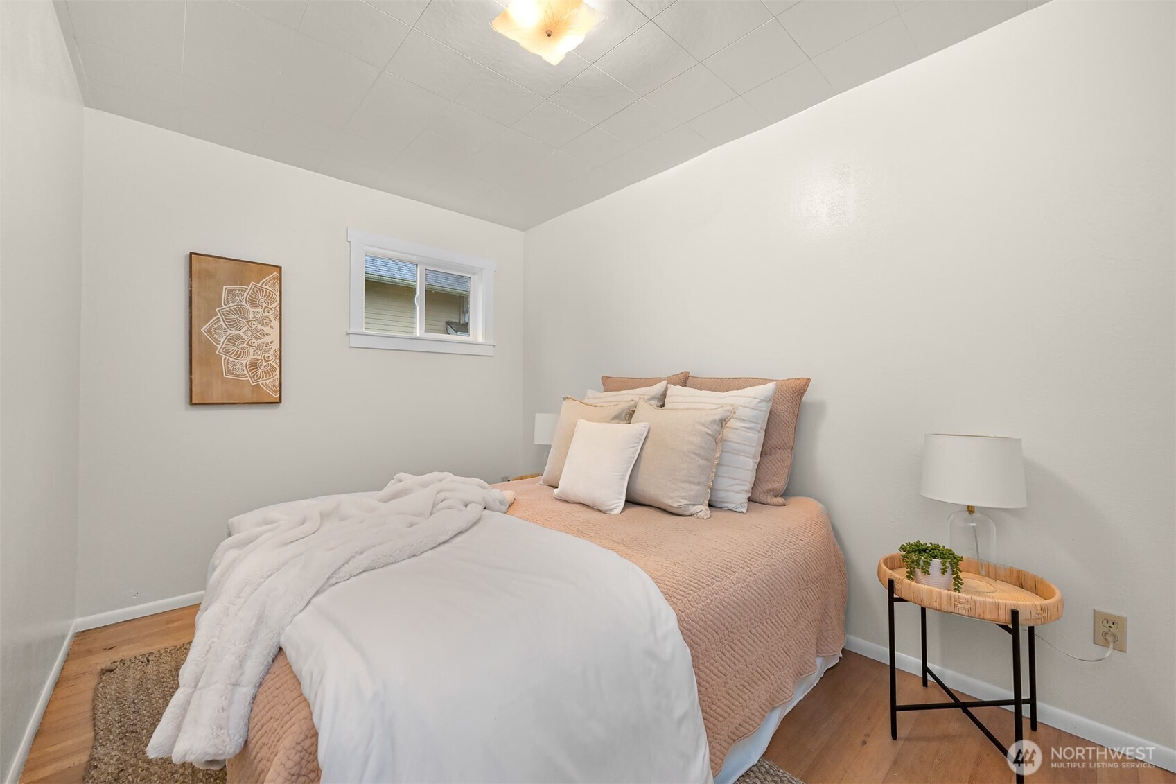 5811 Main Street Bow, WA 98232 - Photo 32 of 40 a large bed sitting in a bedroom next to a lamp