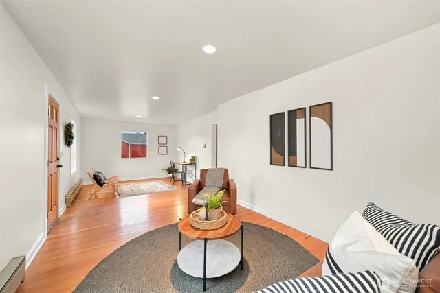 a living room with furniture and wooden floor