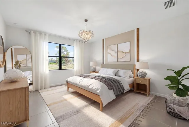 a spacious bedroom with a balcony a bed and a chandelier