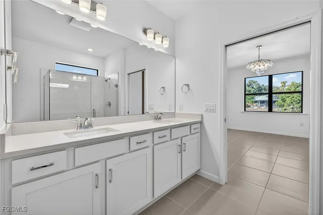 a bathroom with double sink and a mirror