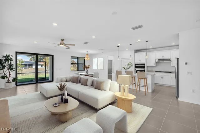 a living room with furniture and kitchen view