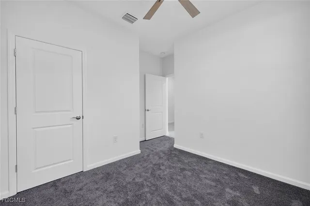 an empty room with closet area