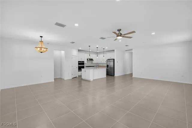 a view of kitchen with furniture and ceiling fan