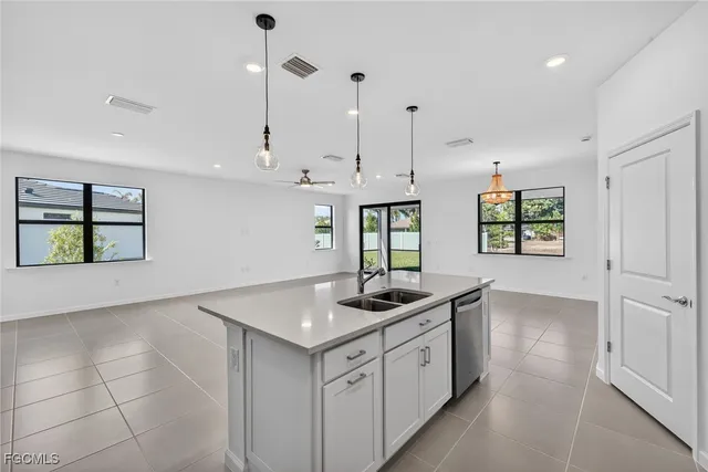 a kitchen that has a sink a window and a counter top space