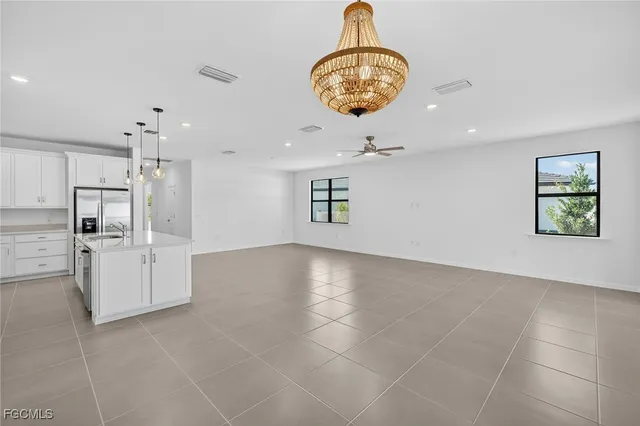 a view of a kitchen with refrigerator and microwave
