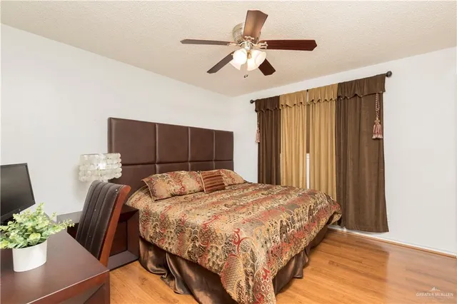 a bedroom with a bed and a potted plant