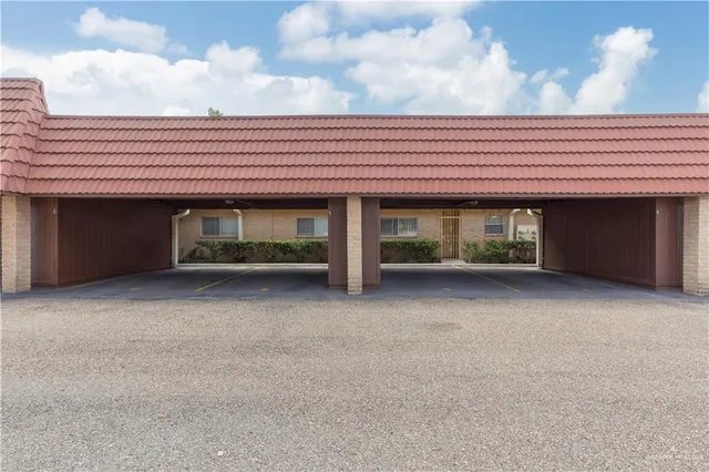 a view of room with balcony and front door