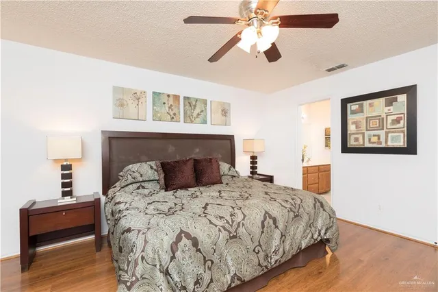 a bedroom with a large bed and a fireplace