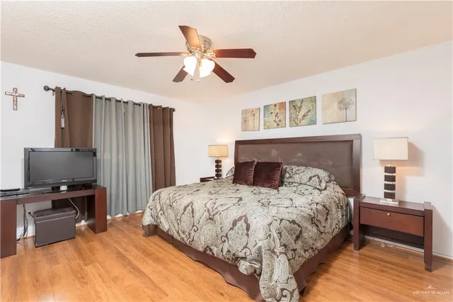a bedroom with a bed and a flat screen tv