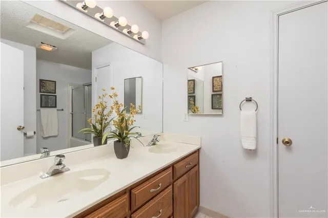 a bathroom with a sink double vanity granite and a mirror