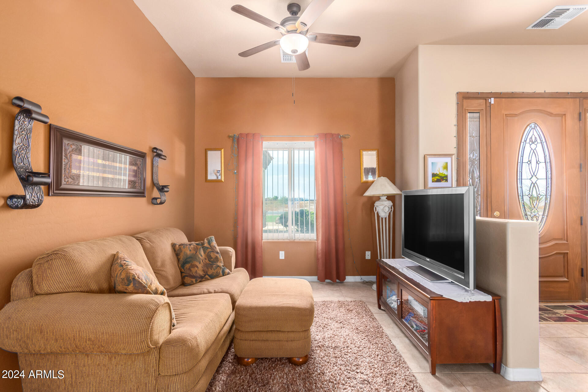 6786 Gelding Lane Coolidge, AZ 85128 - Photo 11 of 39 a living room with furniture and a flat screen tv