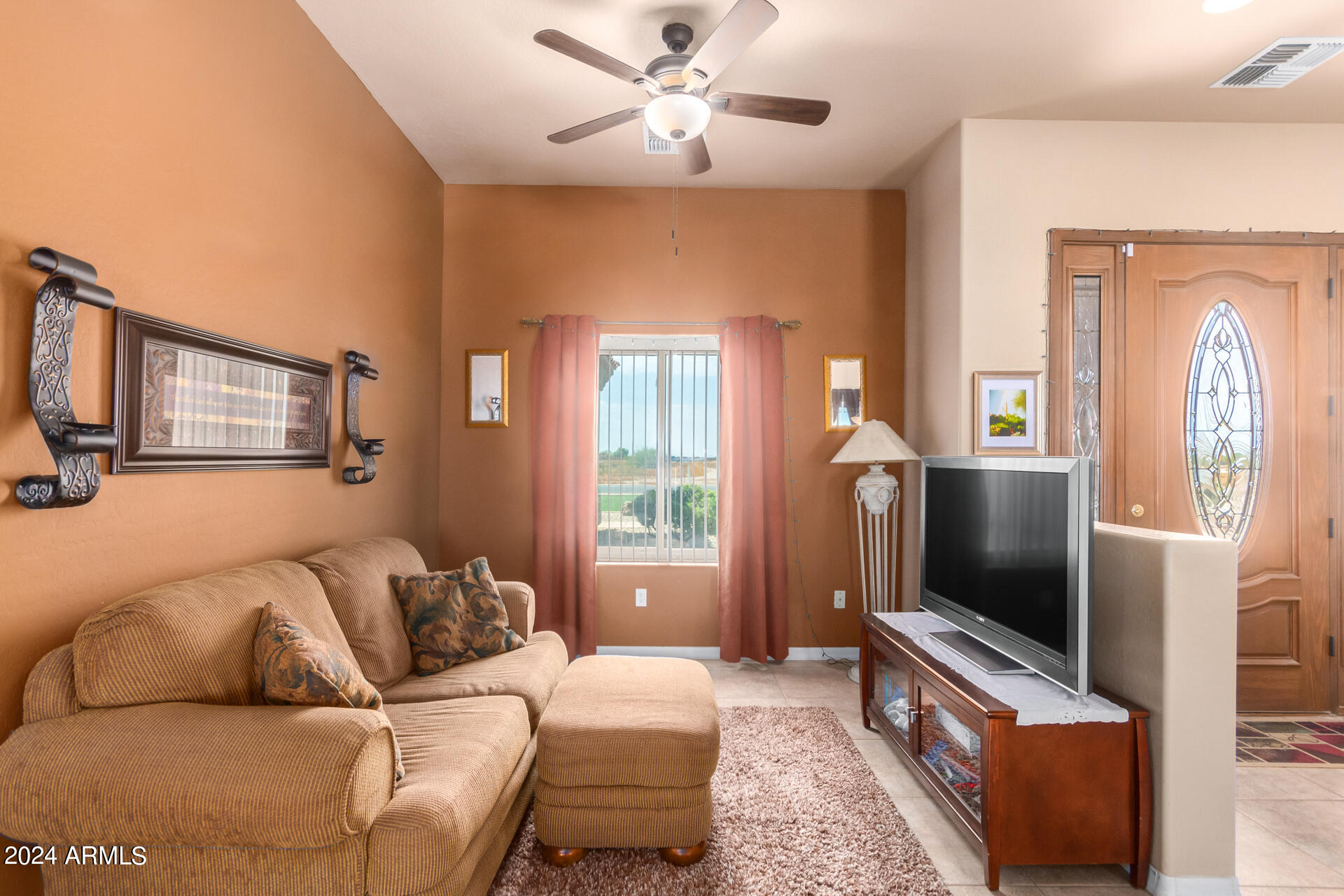 6786 Gelding Lane Coolidge, AZ 85128 - Photo 12 of 39 a living room with furniture and a flat screen tv