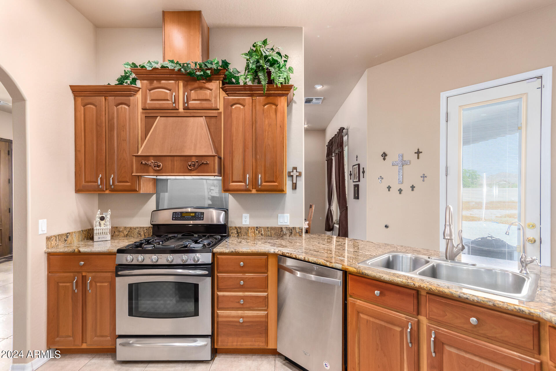 6786 Gelding Lane Coolidge, AZ 85128 - Photo 19 of 39 a kitchen with stainless steel appliances a stove a sink and a refrigerator