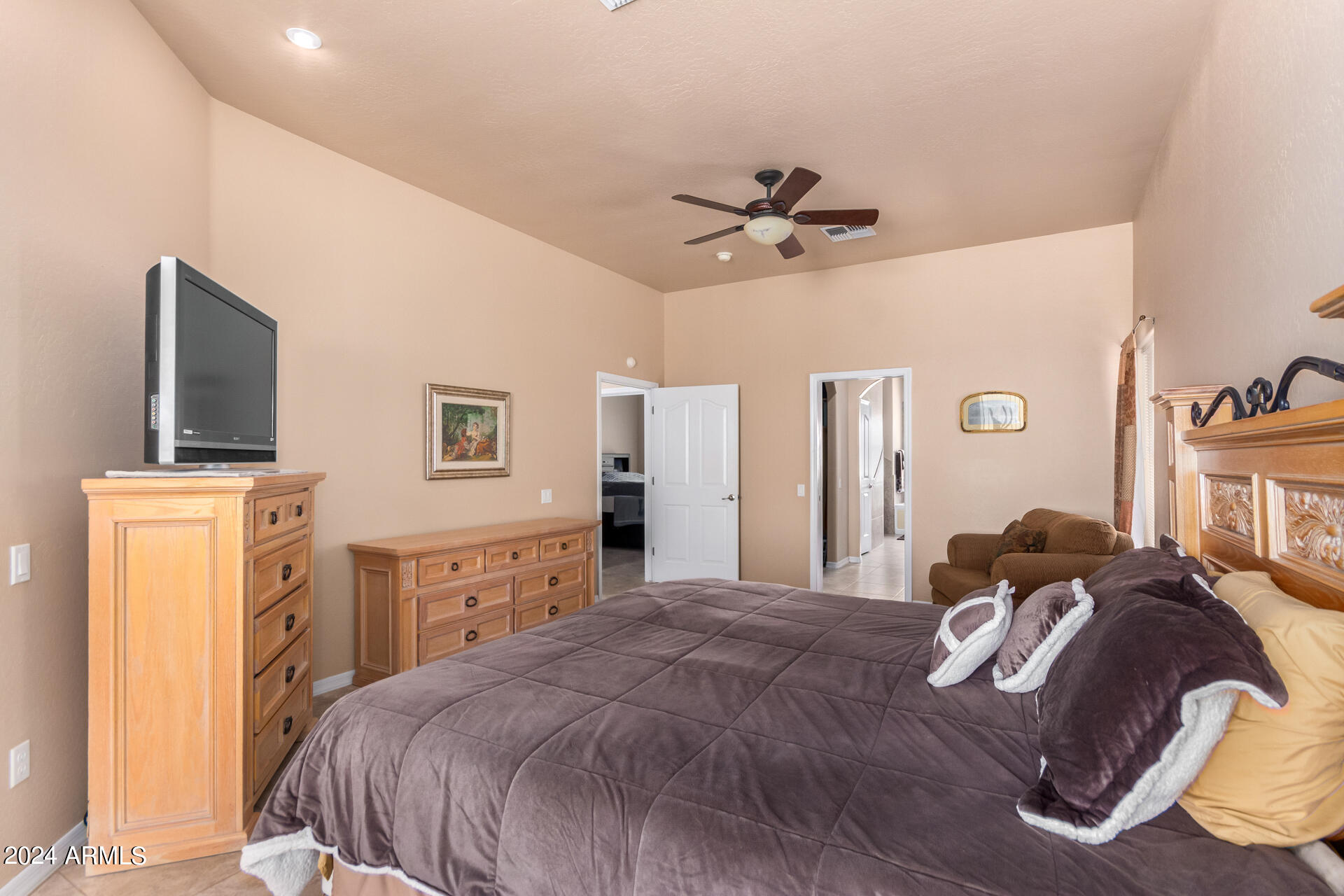 6786 Gelding Lane Coolidge, AZ 85128 - Photo 24 of 39 a bedroom with a bed and a chandelier