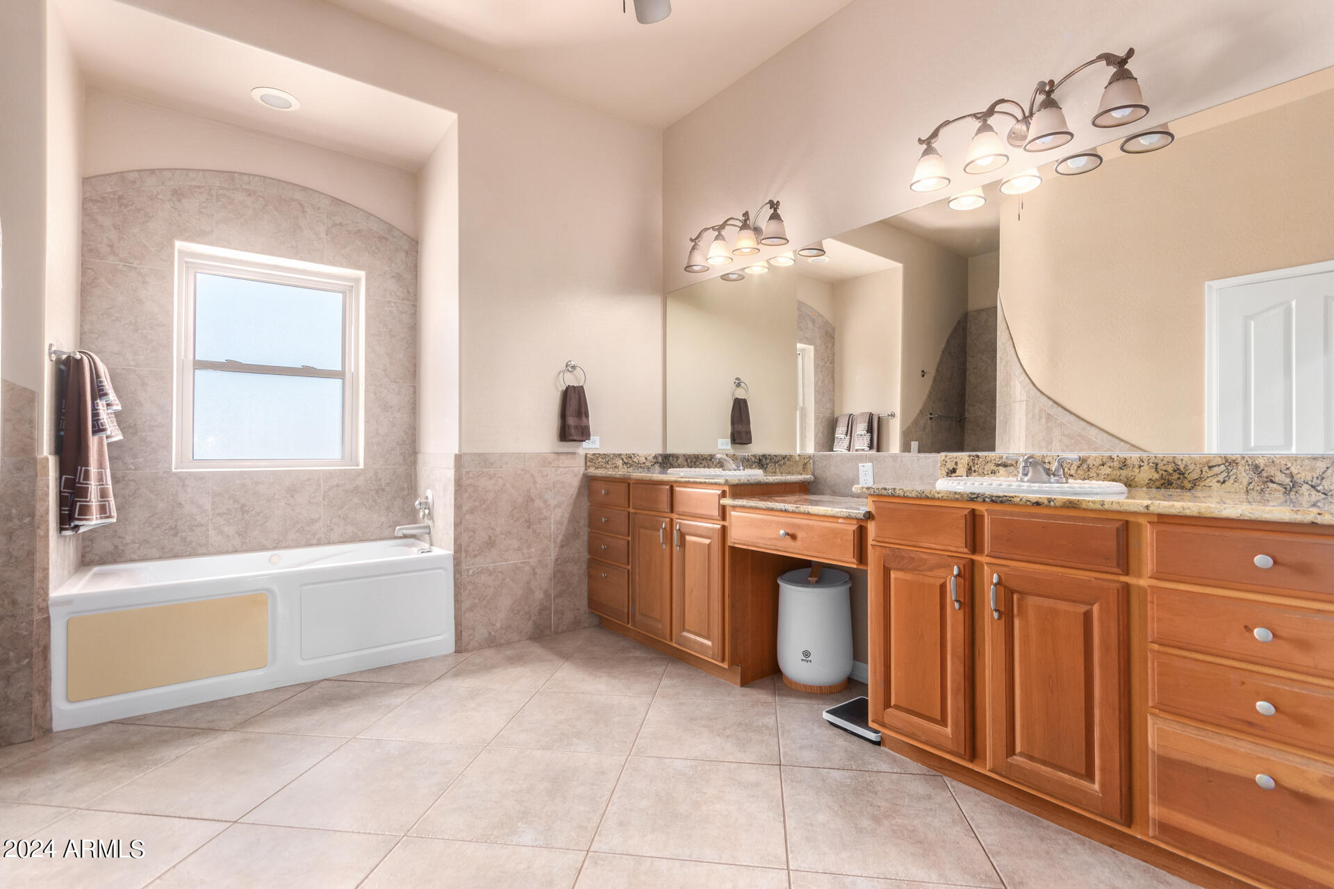 6786 Gelding Lane Coolidge, AZ 85128 - Photo 27 of 39 a spacious bathroom with a granite countertop sink a toilet a mirror and bathtub