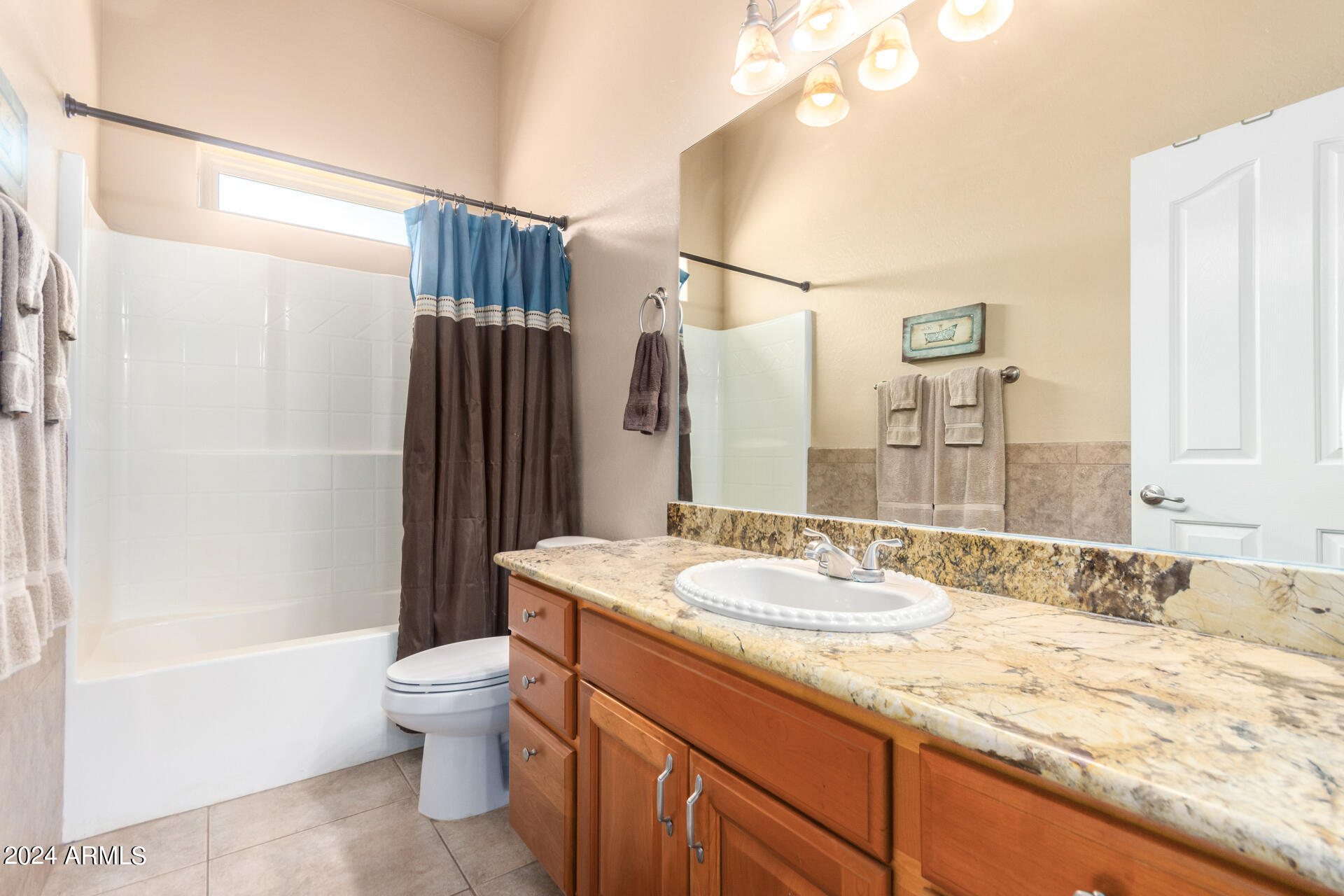6786 Gelding Lane Coolidge, AZ 85128 - Photo 36 of 39 a bathroom with a granite countertop sink a toilet and shower