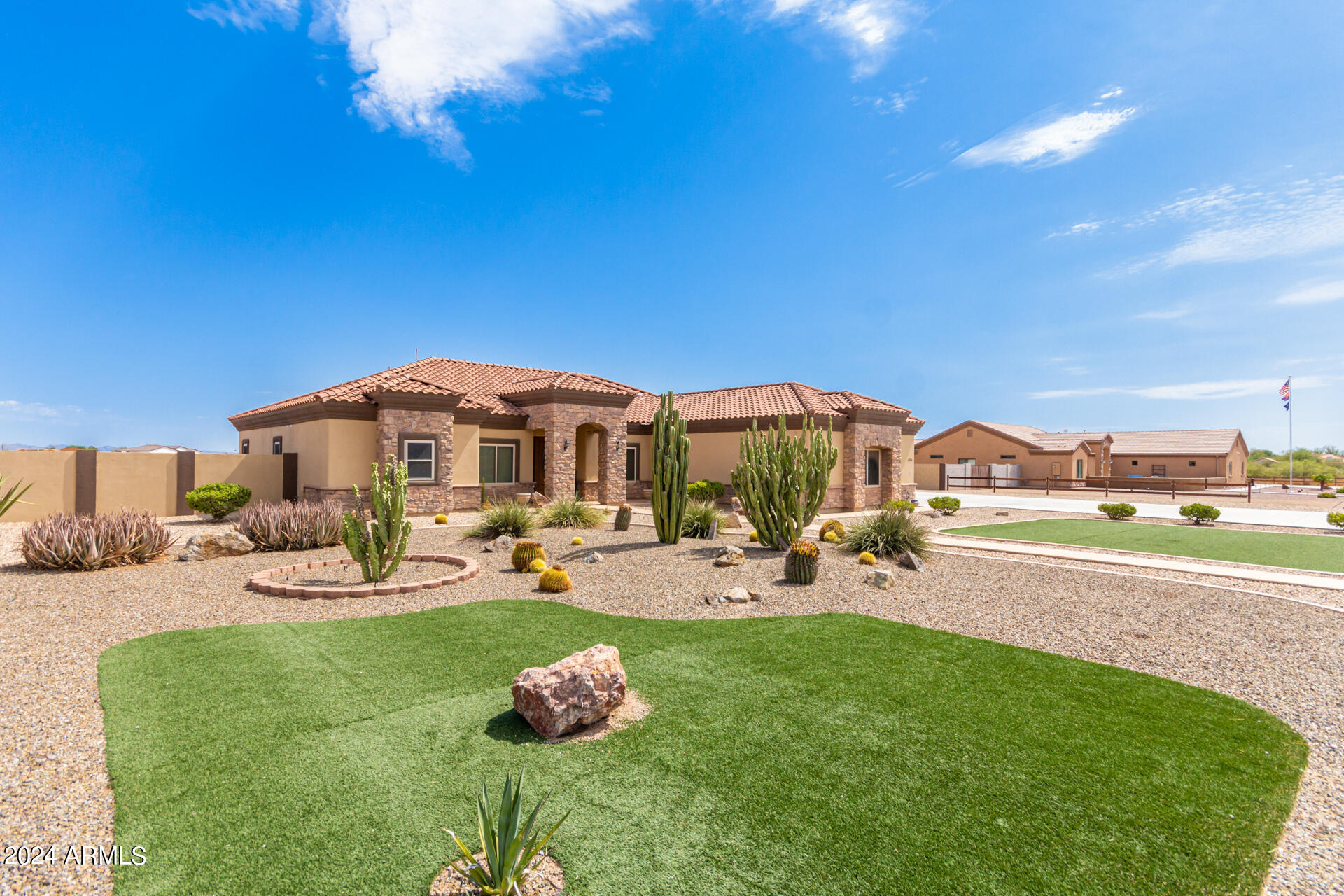 6786 Gelding Lane Coolidge, AZ 85128 - Photo 4 of 39 a view of a backyard with table and chairs under an umbrella