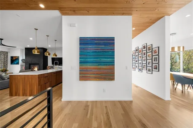 a kitchen with a stove and a flat screen tv
