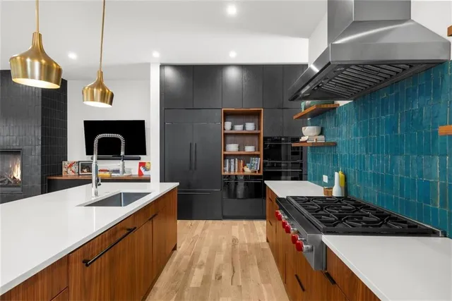 a kitchen with stainless steel appliances granite countertop a refrigerator and a stove