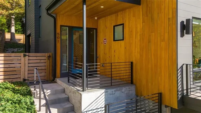 a large kitchen with stainless steel appliances kitchen island a large counter top a stove and a sink