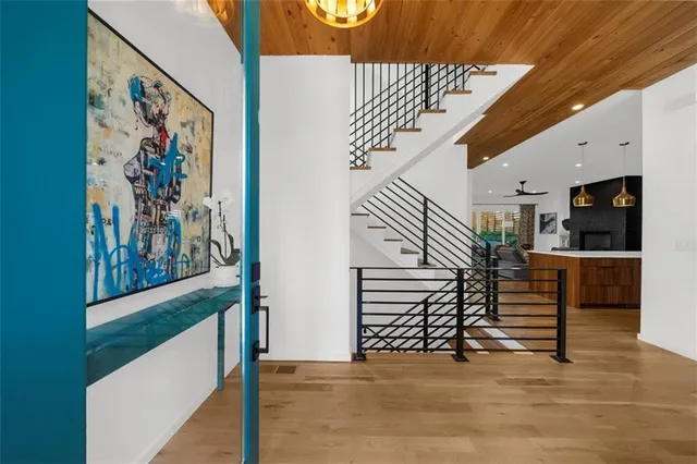 a kitchen with stainless steel appliances kitchen island granite countertop a stove a sink and a refrigerator