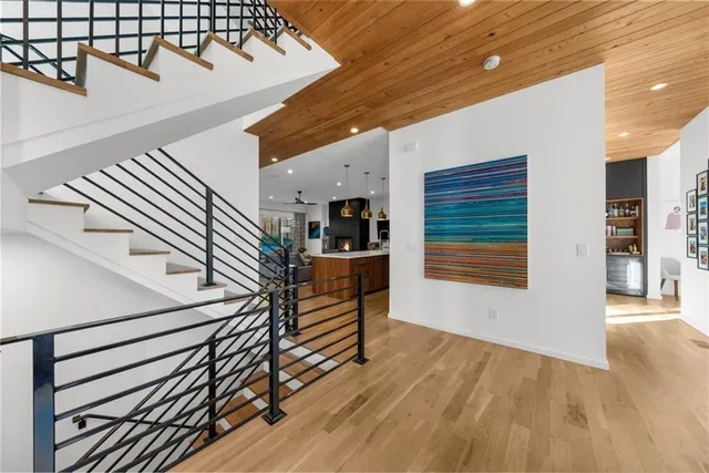 a kitchen with stainless steel appliances granite countertop a sink a stove and a wooden floors