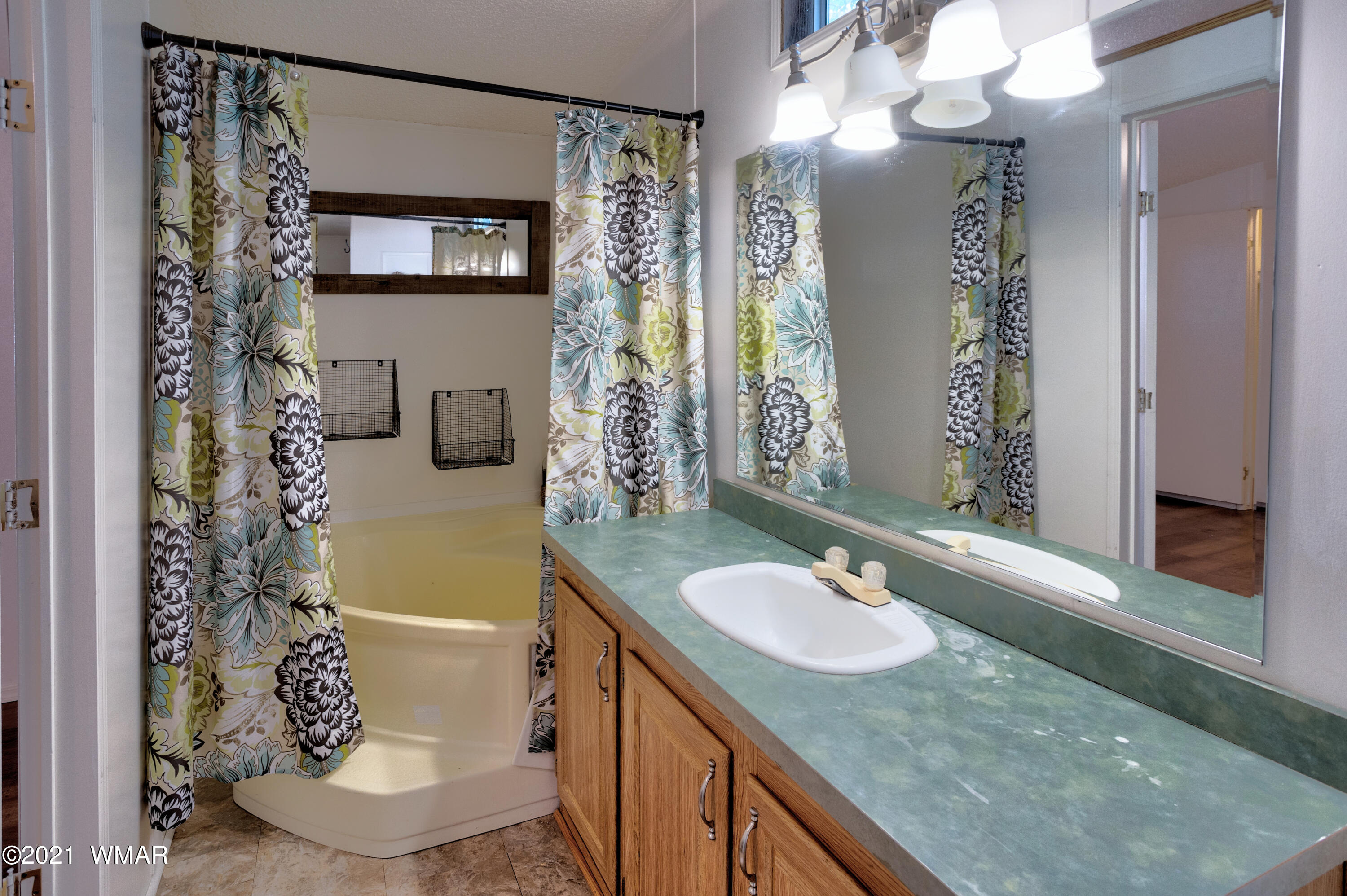 5232 South Blue Ridge Loop Pinetop, AZ 85935 - Photo 12 of 18 a bathroom with a granite countertop sink and a mirror