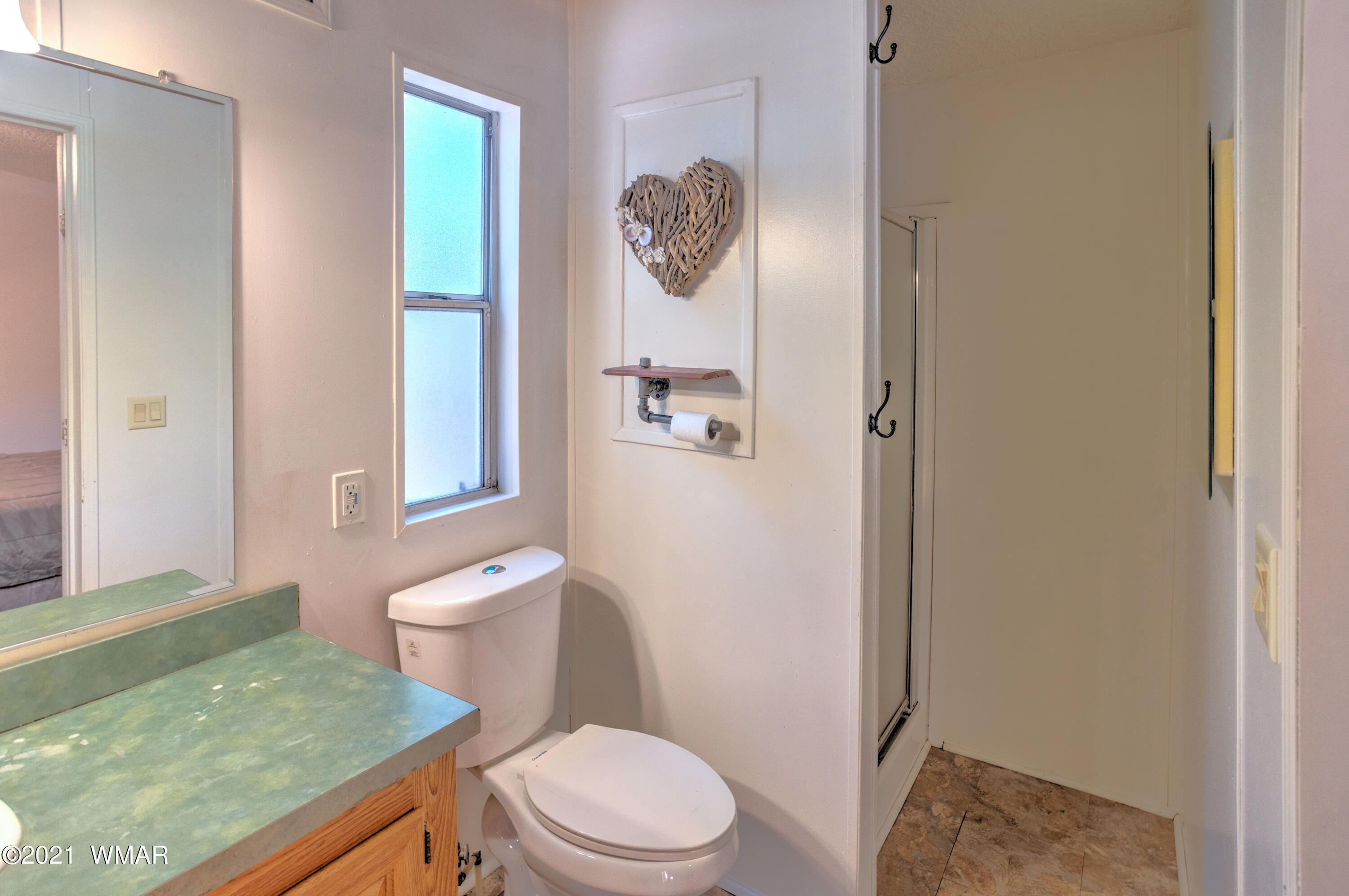 5232 South Blue Ridge Loop Pinetop, AZ 85935 - Photo 13 of 18 a bathroom with a granite countertop sink a toilet and a shower
