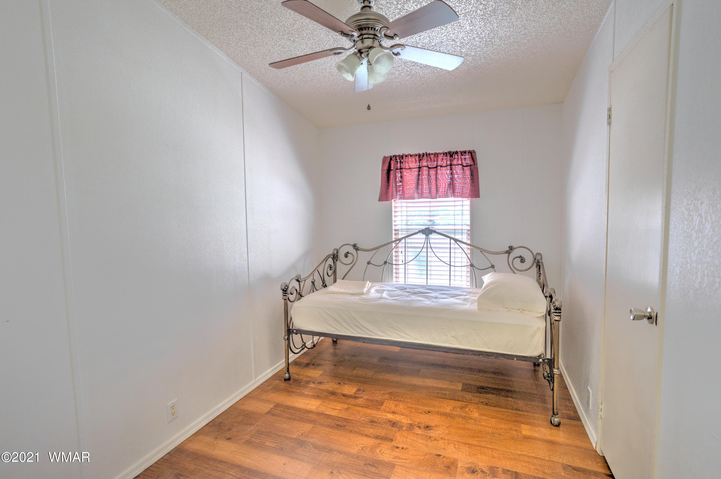 5232 South Blue Ridge Loop Pinetop, AZ 85935 - Photo 14 of 18 a view of a bedroom with a bed and dresser