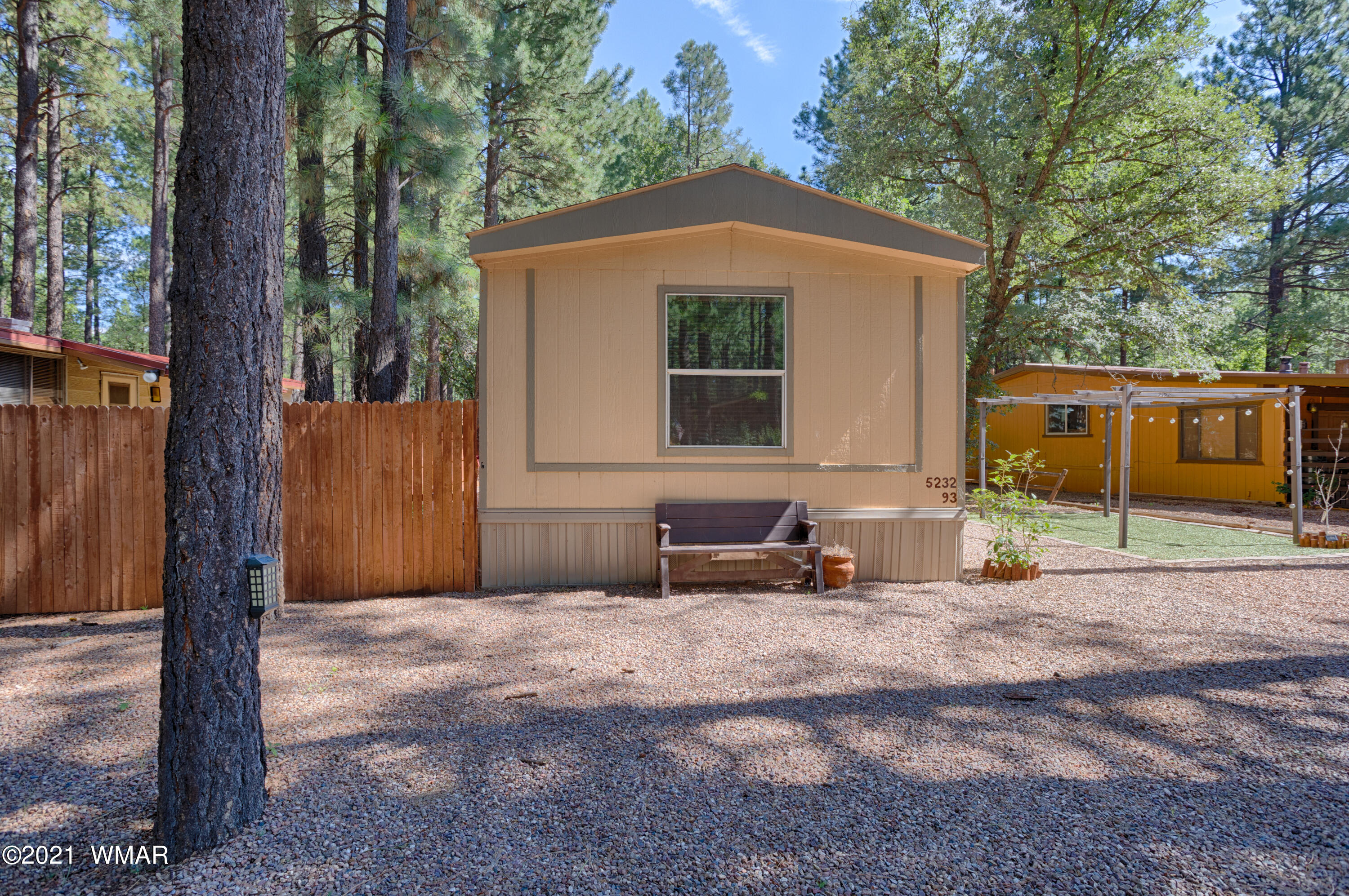 5232 South Blue Ridge Loop Pinetop, AZ 85935 - Photo 2 of 18 a backyard of a house with table and chairs