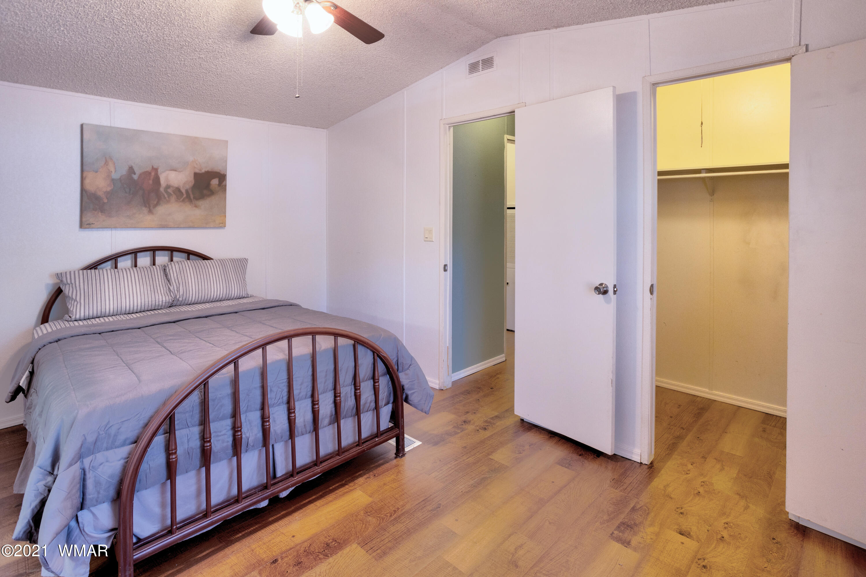 5232 South Blue Ridge Loop Pinetop, AZ 85935 - Photo 10 of 18 a bedroom with a bed and wooden floor