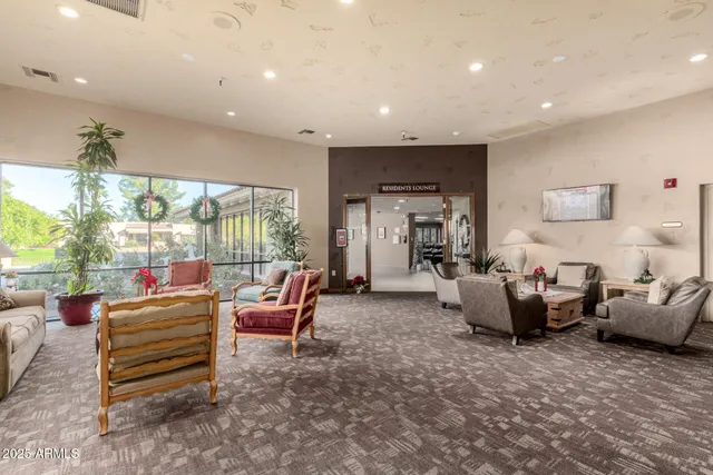 a dining space with furniture and a floor to ceiling window