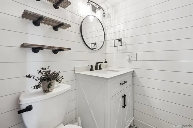 a bathroom with a sink a toilet and a mirror