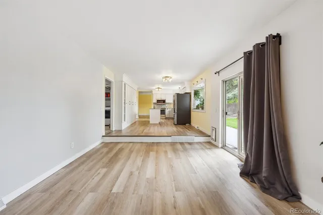a view of a living room hardwood floor and a large window