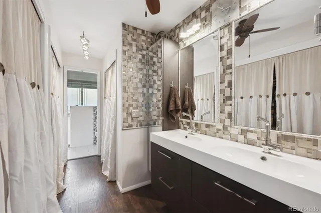 a bathroom with a double vanity sink mirror and shower