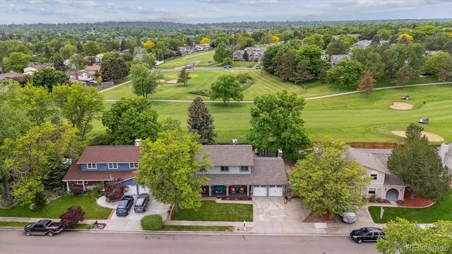 an aerial view of multiple houses with yard