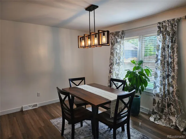 a view of a dining room with furniture window and wooden floor
