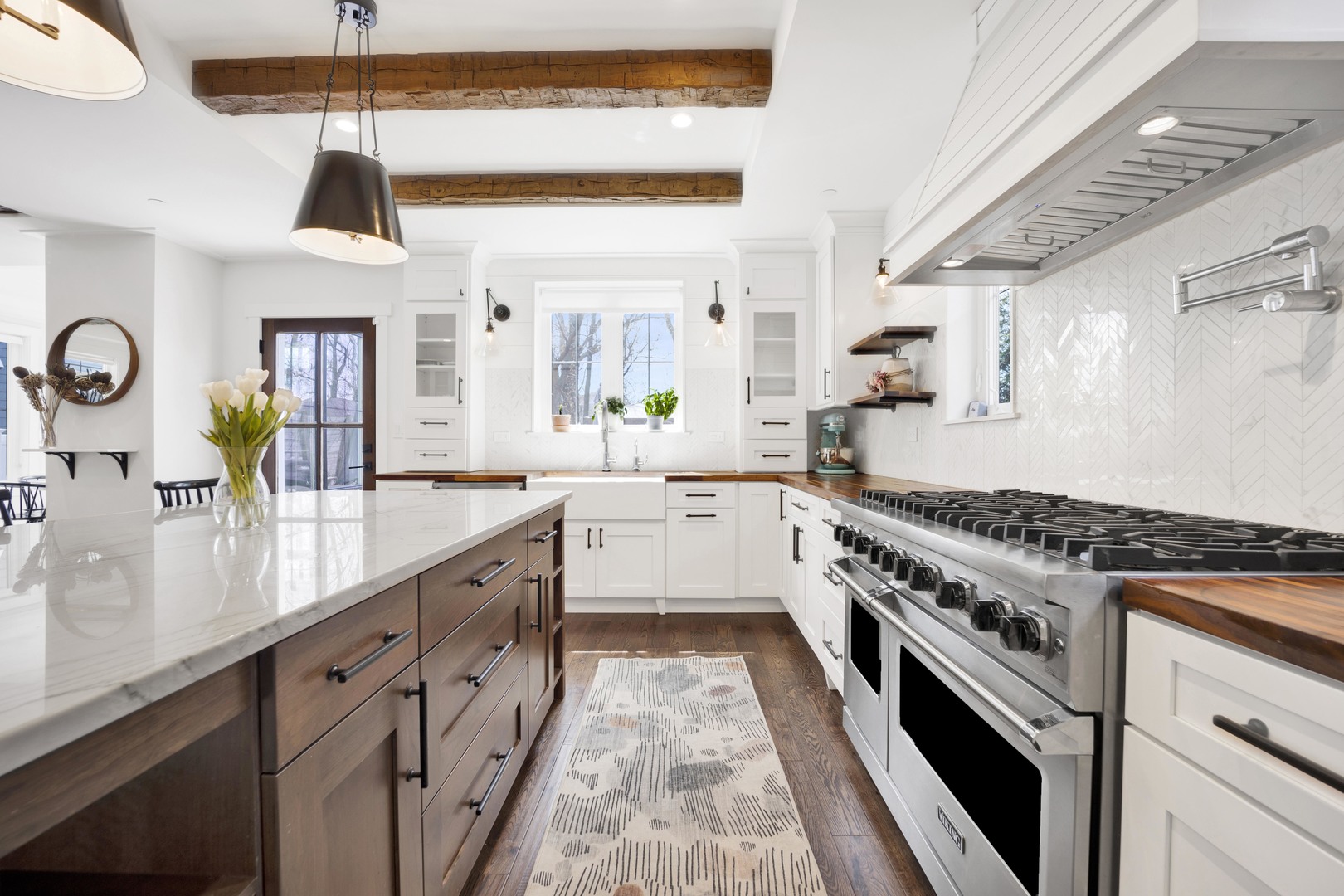 317 Lionel Road Riverside, IL 60546 - Photo 8 of 47 a large kitchen with stainless steel appliances granite countertop a stove a sink dishwasher and white cabinets with wooden floor