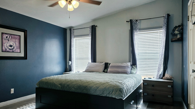 401 West 2000th Street South Vernal, UT 84078 - Photo 9 of 26 Vaulted ceiling with a ceiling fan, dual windows with blinds, a built-in wall shelf, and wood-finish flooring