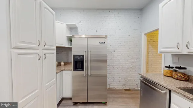 a kitchen with a refrigerator and cabinets