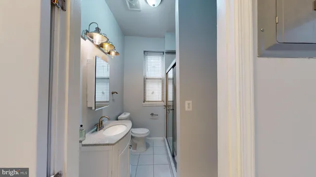 a bathroom with a toilet a sink and mirror