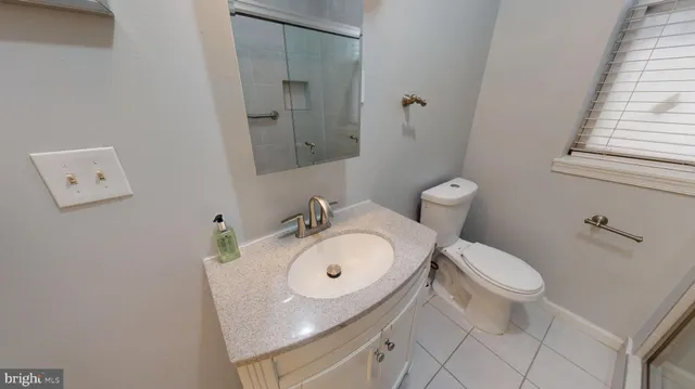a white toilet sitting next to a bathroom sink
