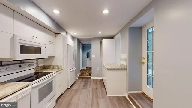 a kitchen with a refrigerator and a sink