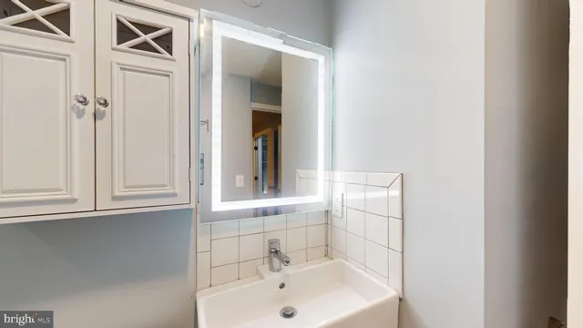 a bathroom with a sink and mirror
