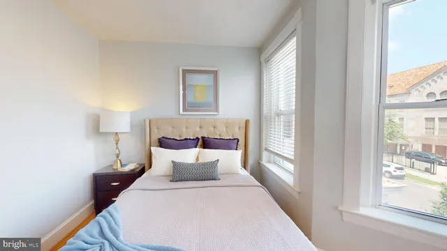 a bedroom with a large bed and a night stand