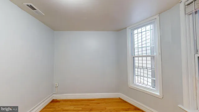 a view of a room with rack on the wall and a window