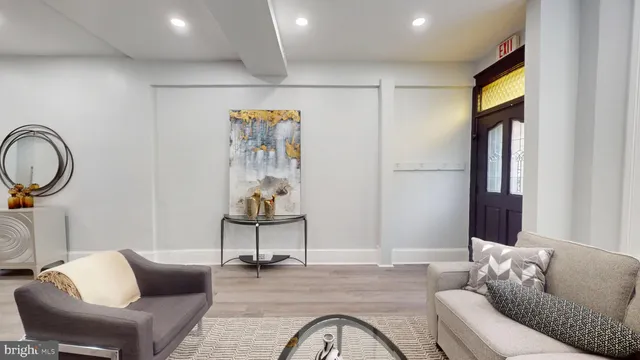 a living room with furniture and a painting