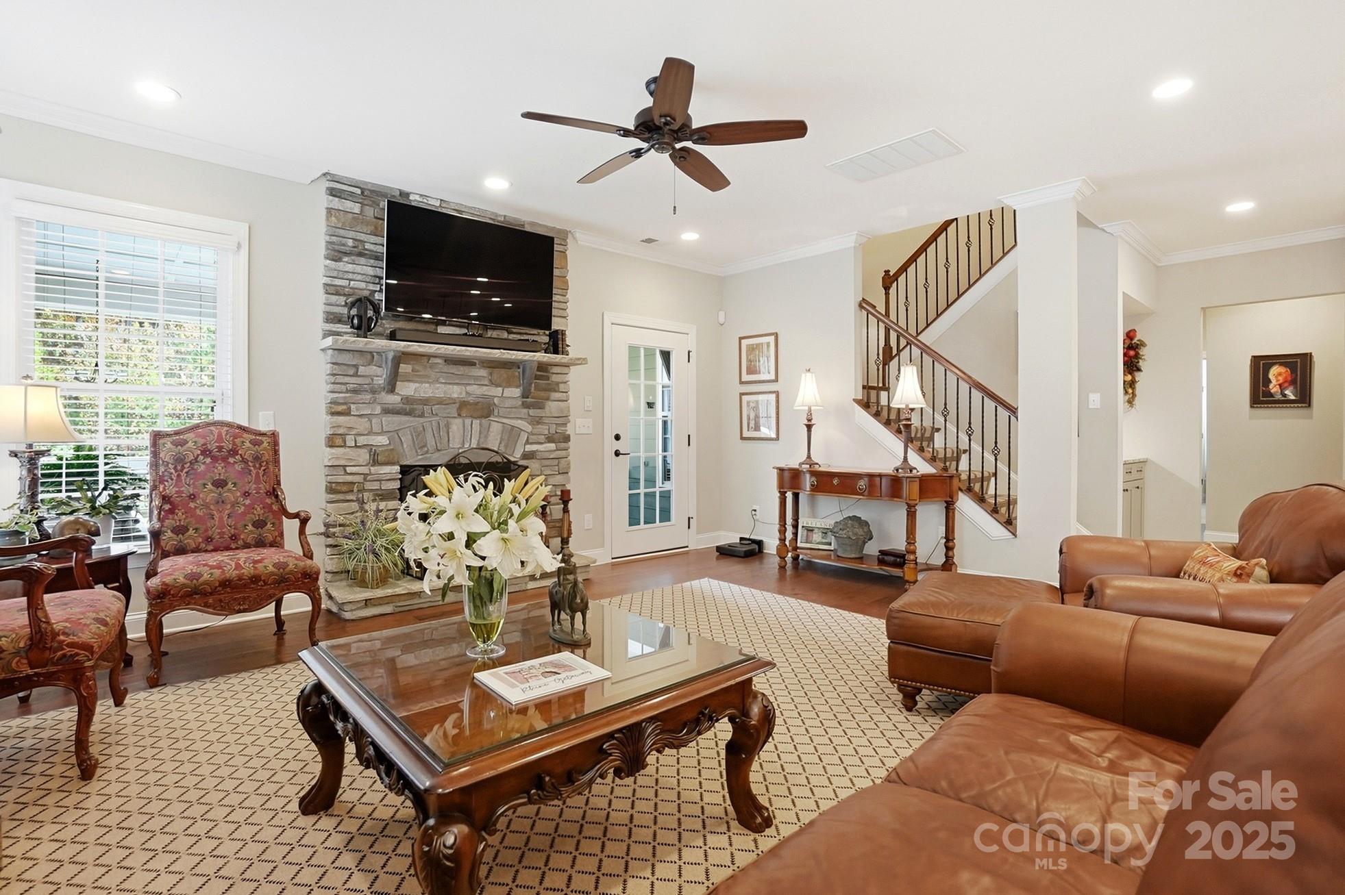 4069 Henshaw Road Waxhaw, NC 28173 - Photo 12 of 48 a living room with furniture a flat screen tv and kitchen view