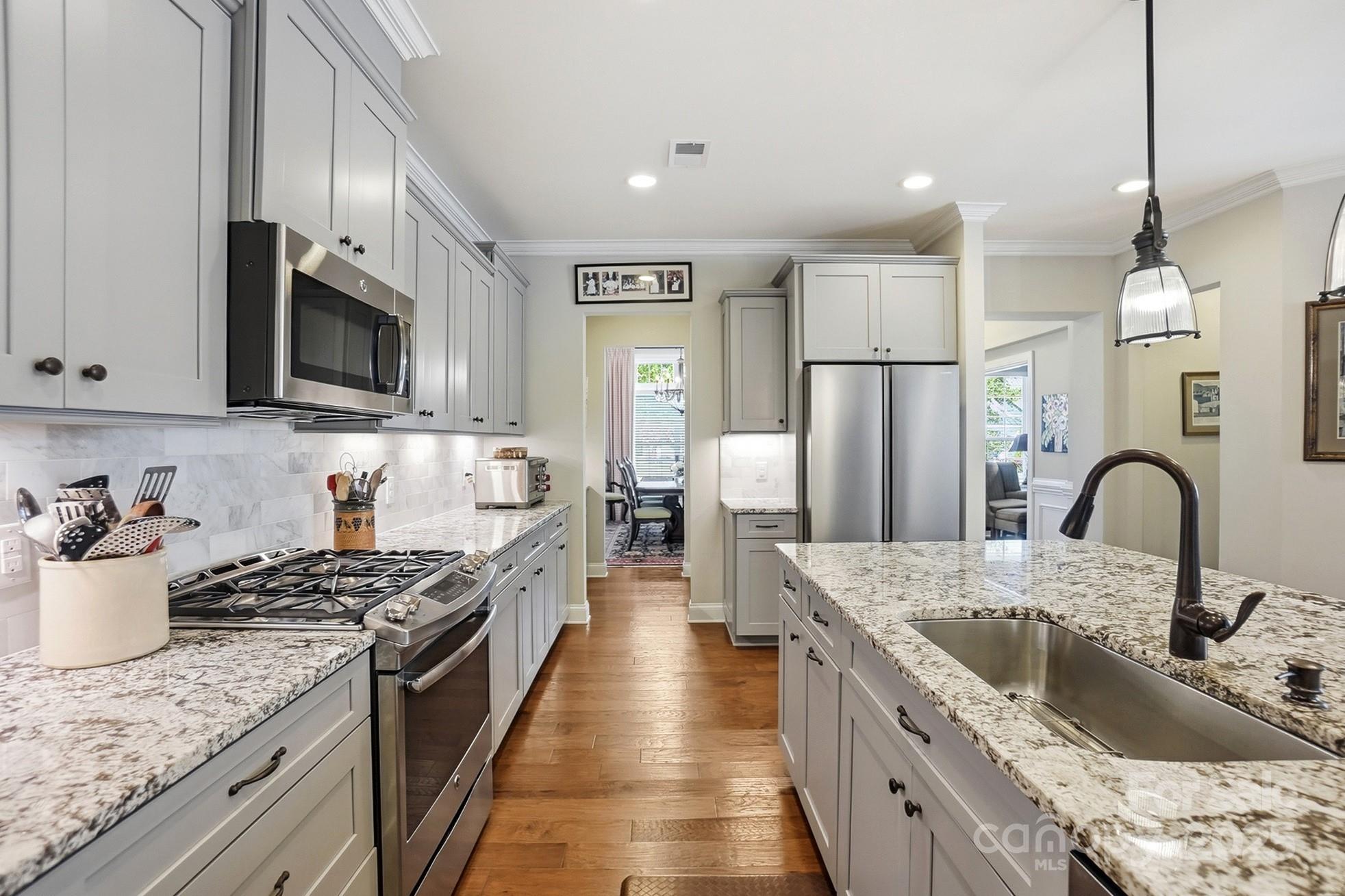 4069 Henshaw Road Waxhaw, NC 28173 - Photo 16 of 48 a kitchen with stainless steel appliances granite countertop a sink stove and refrigerator